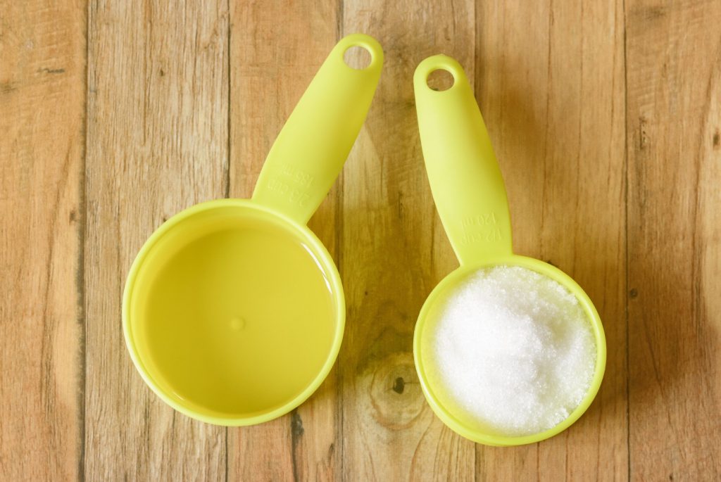 Measuring cups with sugar and oil