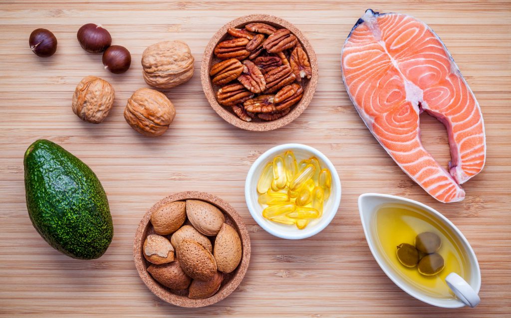 Healthy fat foods including salmon, avocado, nuts