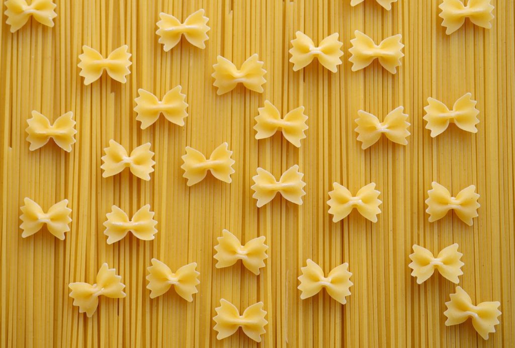 Bowtie pasta on top of linguine 