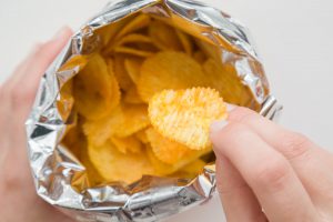 Hand pulling snack from bag