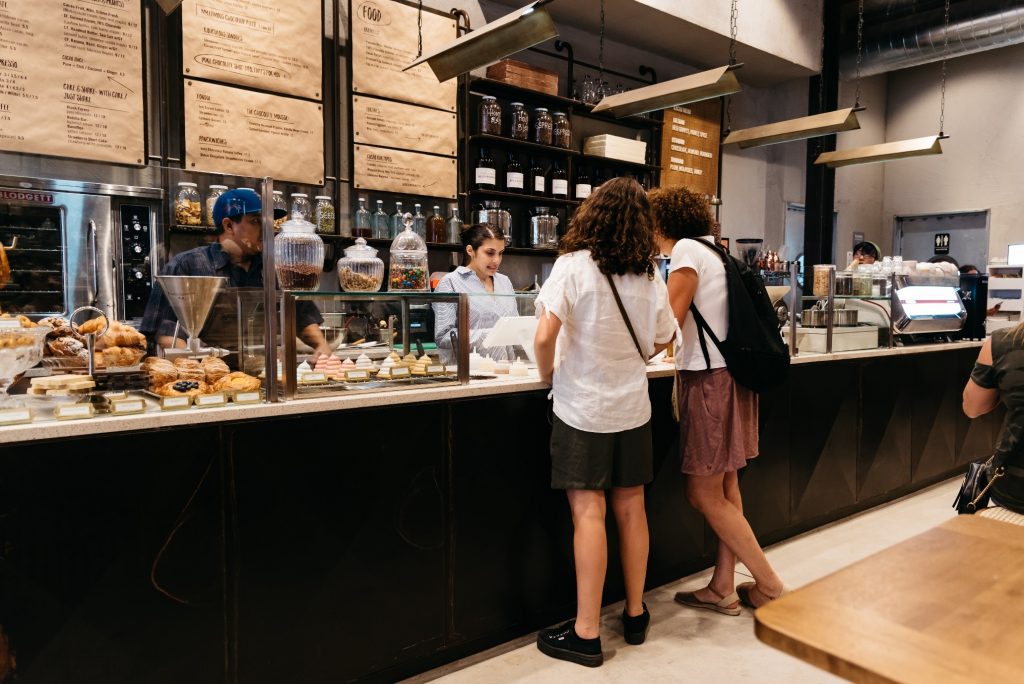 People ordering food at cafe