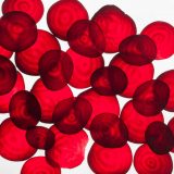Thin slices of beet on white background